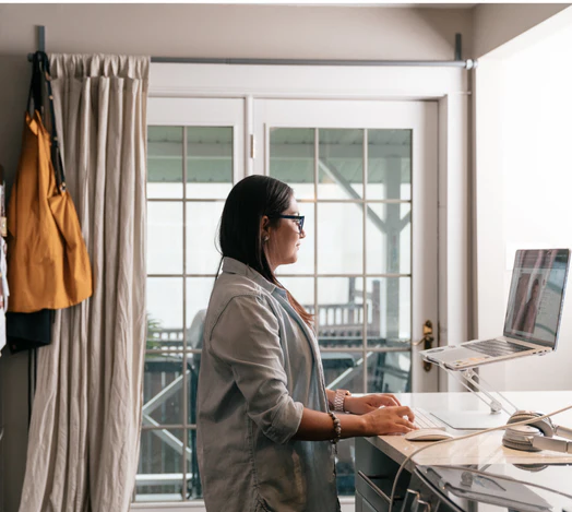 A Shopify intern working from home at a standing desk